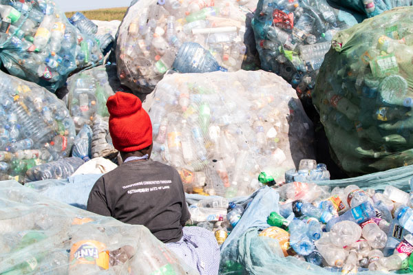 A woman sorts plastic bottles at Gioto Dumping site in Nakuru