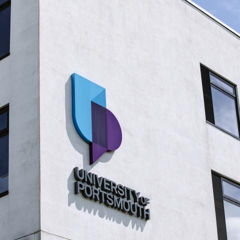 corner of University of Portsmouth building with logo