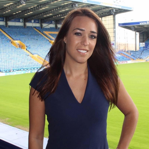 Anna Mitchell smiling to camera with Portsmouth Football Club in the pitch