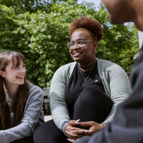 Three people laughing together 