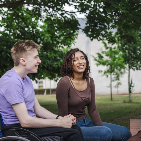 Three students laughing together 