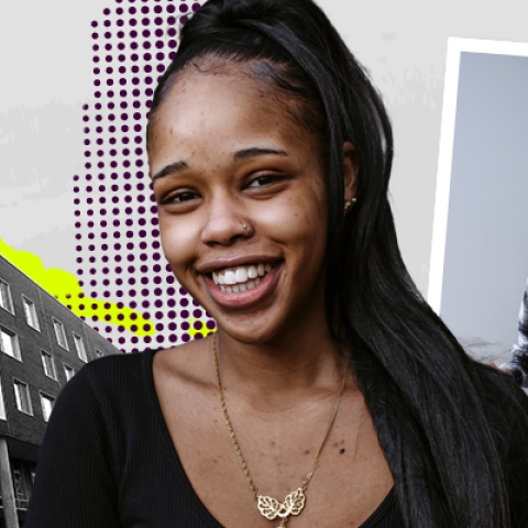 A female student smiling and two students looking through a book