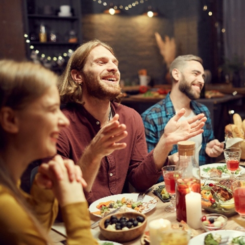 Group of people having dinner and smiling together