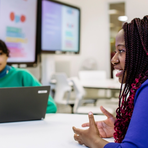 Woman in purple top presenting