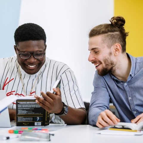 Two students looking at a book together