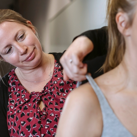 Woman performing a bra fitting