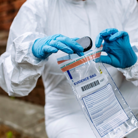 Forensics student puts crime evidence in bag