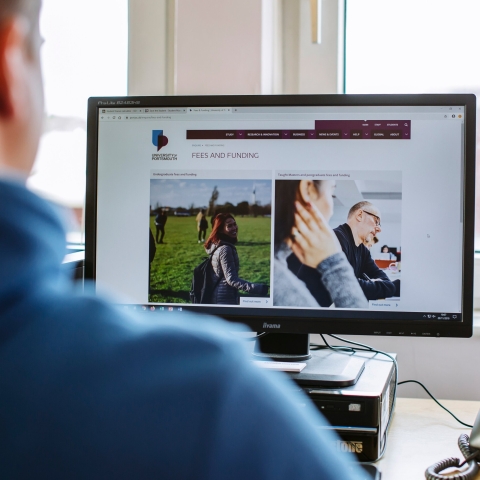 Student researching fees and funcing