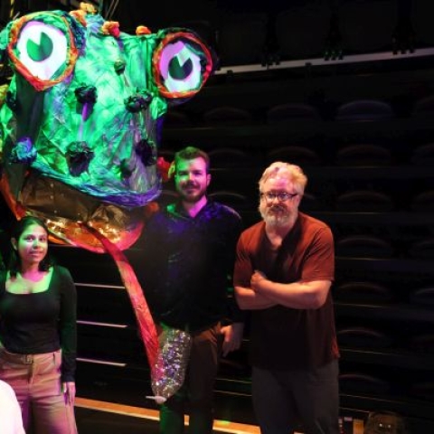 Dr Matt Smith with researchers with the 'Enzyme Eating Monster' puppet