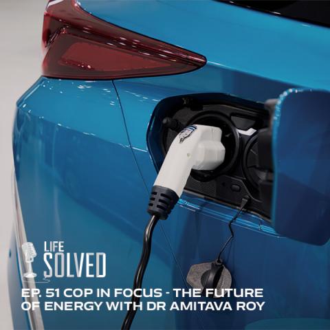 Blue electric car at a charging station. Life Solved logo and title
