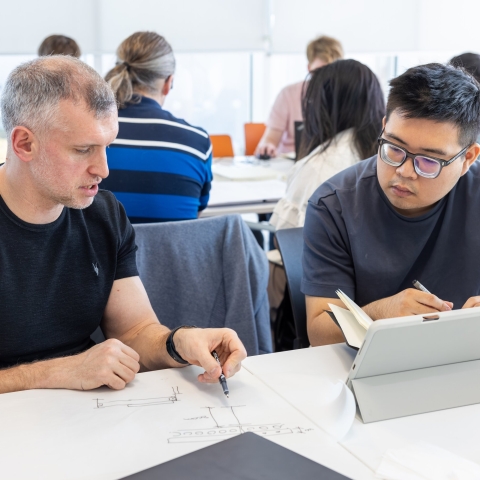 Two people working on a document together 