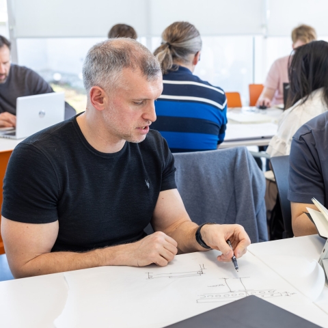 Two people working on a document together 