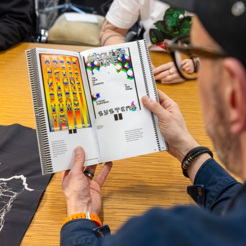 academic looking at a graphioc design book