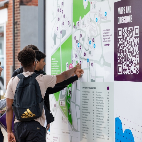 Visiting students looking at large campus map to help navigate  - Open Day 2023