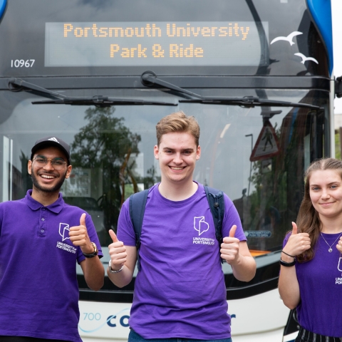 Three student ambassadors standing by Park and Ride bus - Open Day 2023