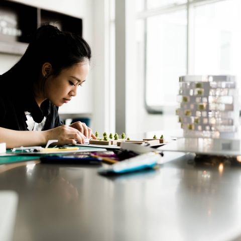 A student working on a 3D architecture model