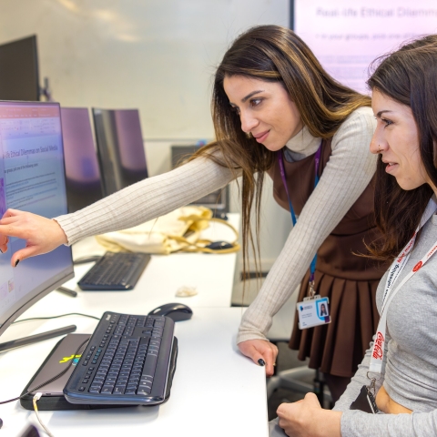 two students working on a project on a computer