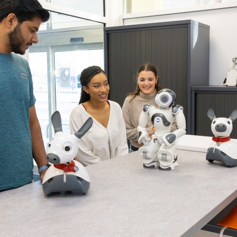Students with humanoid and animalistic robots.