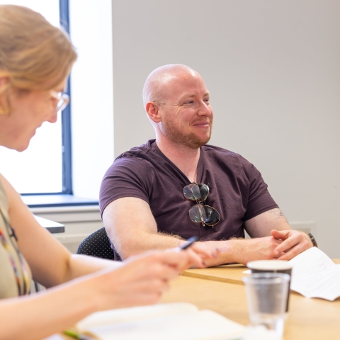 Two adults having a meeting at a desk