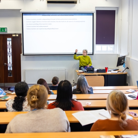 University lecturer presenting to students in lecture theatre