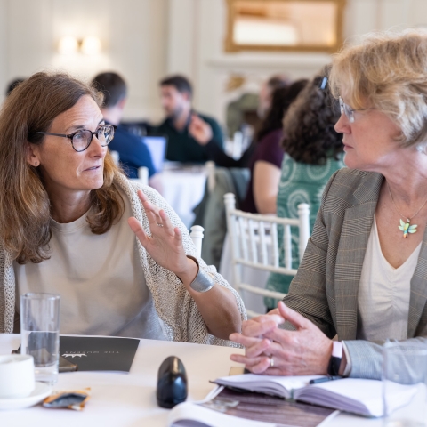 Two women discussing ideas at a desk