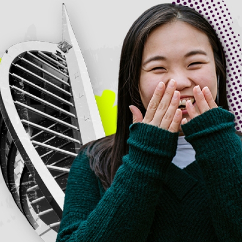 Female student smiling with Spinnaker Tower