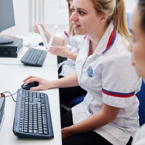 female nurse at computer analysing data