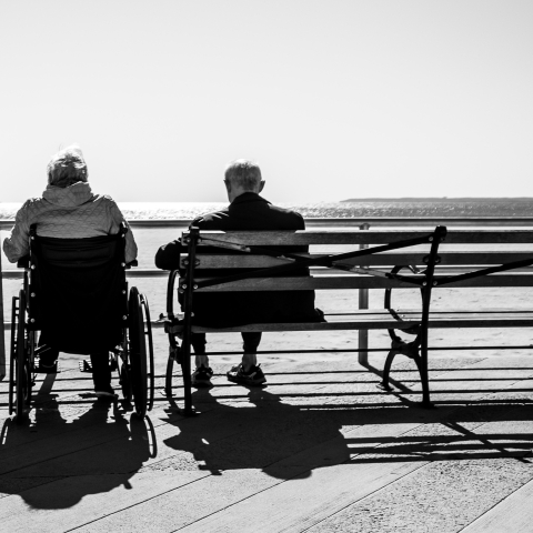 Elderly couple sitting by the beach - Photo by Bruno Aguirre on Unsplash