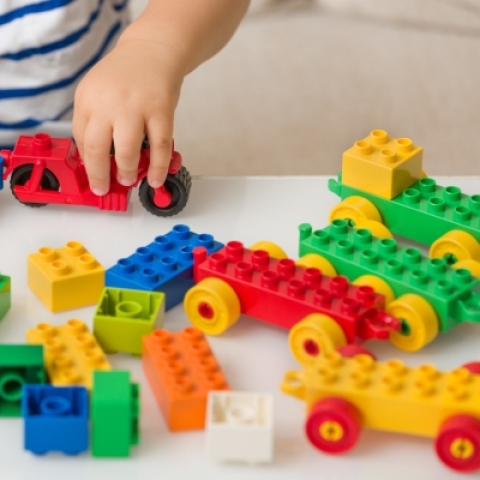 Child playing with Lego