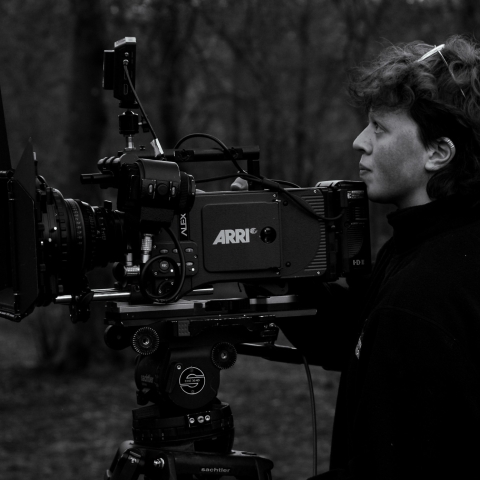 A camera person on location with an Arri Alexa camera