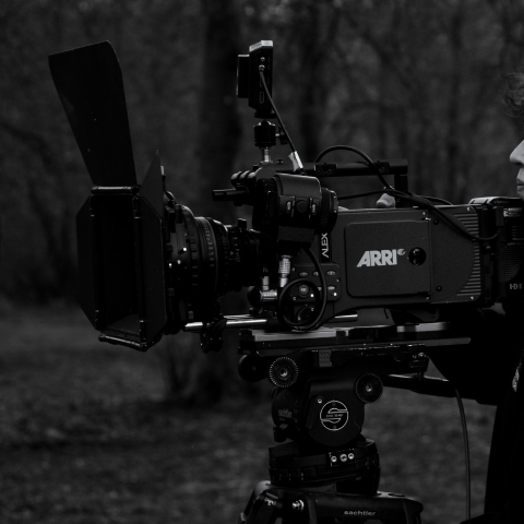A camera person on location with an Arri Alexa camera