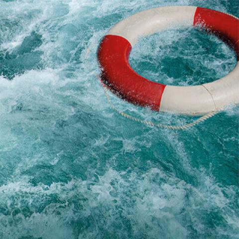 Choppy waters with floating life ring buoy