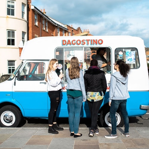 Students buying ice cream from an ice cream van