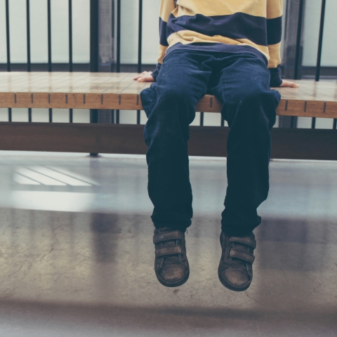Picture of child sitting on a bench