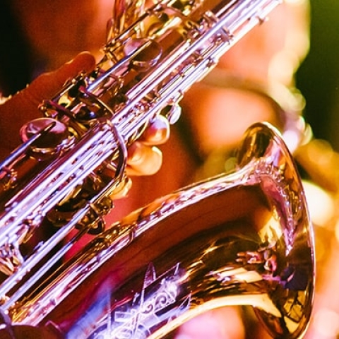 Close up of a saxophone under spotlights at a concert