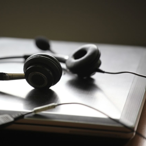 A pair of headphones on a closed laptop