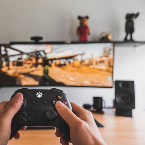 Gaming console in front of video game - Photo by Sam Pak on Unsplash