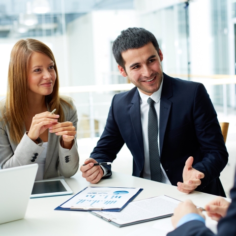 Colleagues discussing business challenges at a table