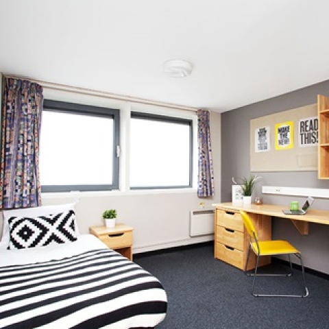 A bedroom in Trafalgar student halls with a bed, desk, and chair