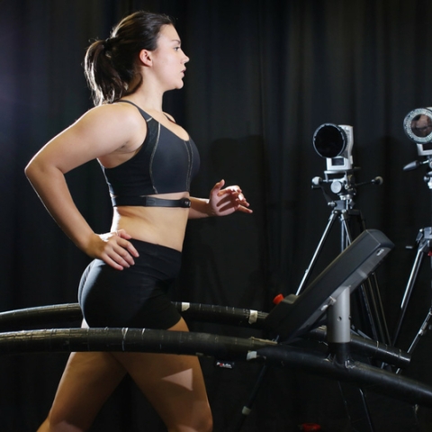 Female runner on treadmill with motion capture cameras 