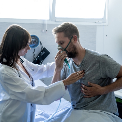 A patient with a respiratory condition being monitored by a medical professional