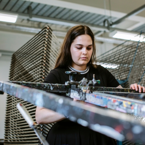 Female University of Portsmouth student using printing press