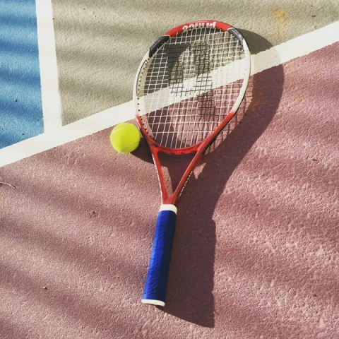 Tennis racket and tennis ball on tennis court