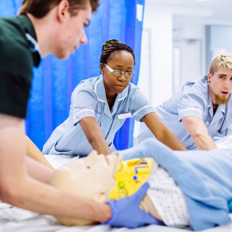 Student nurses treating patient
