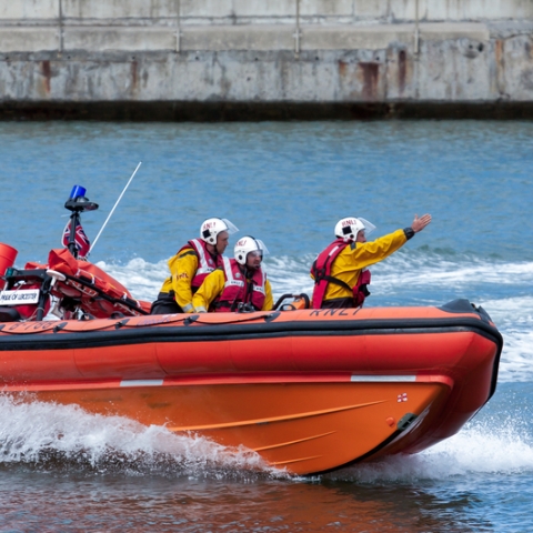 RNLI lifeboat crew in a boat on the water