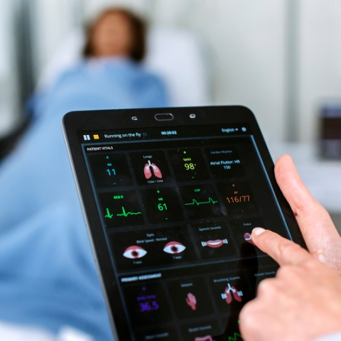 doctor studying vitals on tablet computer
