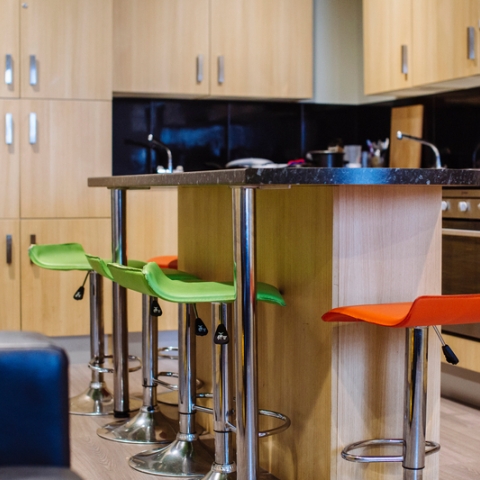 Kitchen in Greetham Street Hall with a breakfast bar and brightly coloured bar stools