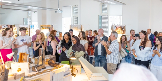 group of people attending graduate show 2025