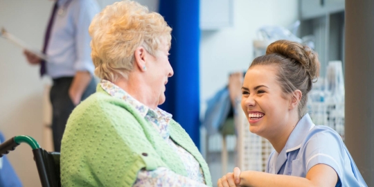 Smiling nurse with elderly patient 