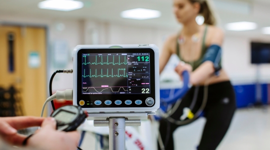  Heart rate monitor tracking student on exercise bike